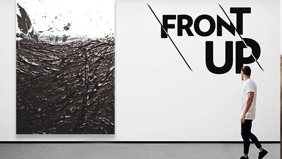 A man walks towards a large abstract artwork with the words 'FRONT UP' above him