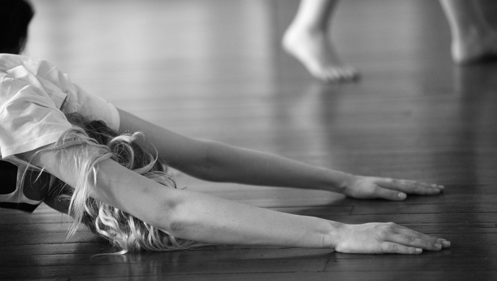 Dance: A dancer leans her arms and head on the floor