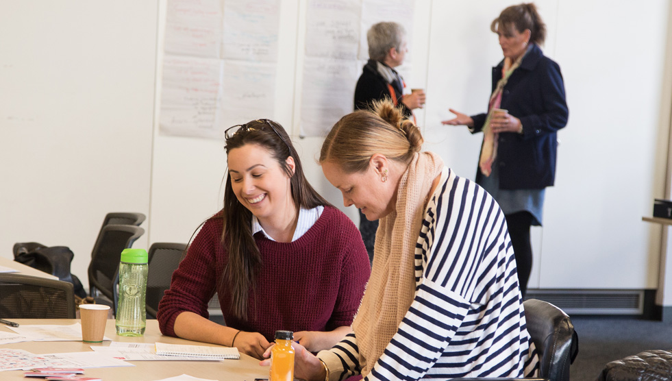 Thomas Banks training: Two women are sitting together at a table
