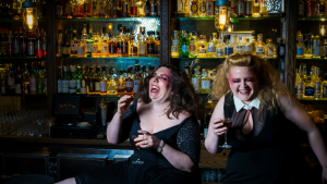 Ticket giveaway: Two women are sitting in a bar and laughing