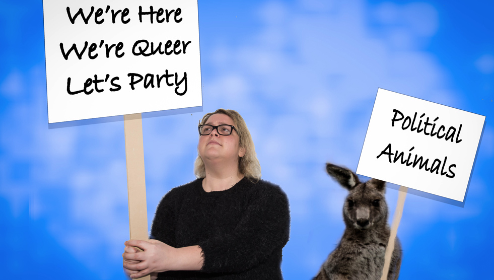 Felicity Nicol: a woman is holding a sign that says "We're here, we're queer, let's party." A kangaroo is holding a sign that says "Political animals."