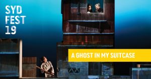 Image of a building with one person on the ground and one person looking out an upper level window. Text says Syd Fest 19, A Ghost In My Suitcase
